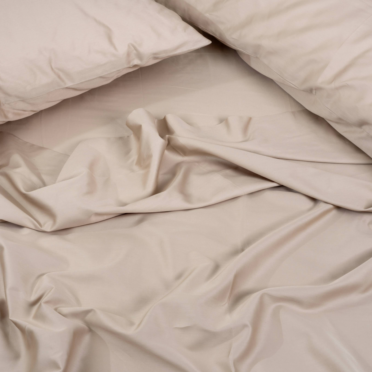 Beige comforter and pillows on a bed